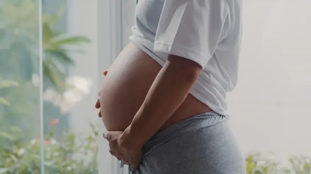 Young Asian Pregnant Woman Holding Her Belly Talking With Her Child Mom Feeling Happy Smiling Positive Peaceful While Take Care Baby Pregnancy Near Window Living Room Home
