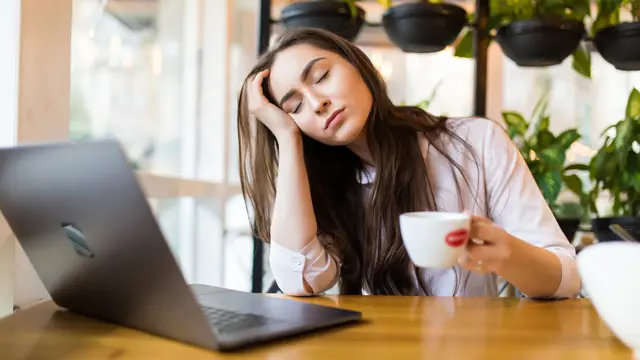 Portrait Tired Young Businesswoman Sitting Table With Laptop Computer While Holding Cup Coffee Sleeping Cafe