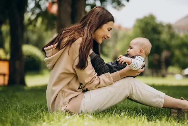 Mother With Her Little Son Park Sitting Grass